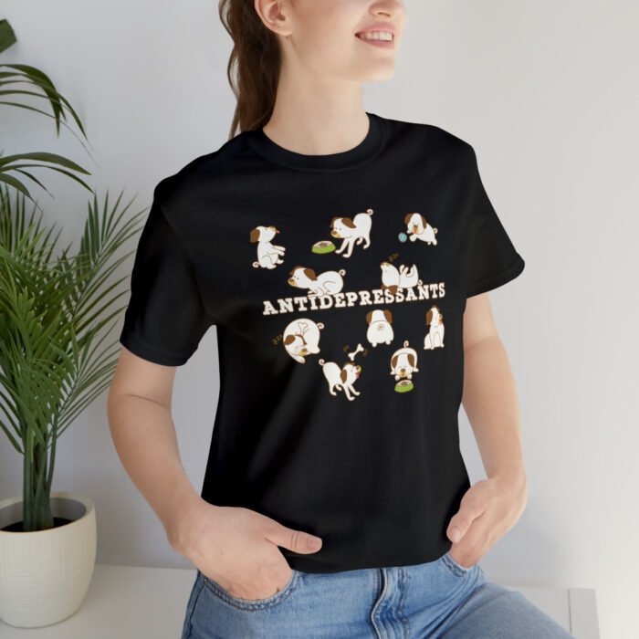 A young woman wearing a black funny T-Shirt for dog lovers with cartoony pictures of funny dogs saying "Antidepressants".