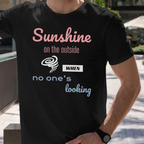 Funny T-Shirt featuring a picture of a little hurricane and saying "Sunshine on the outside, hurricane when no one's looking". Black color