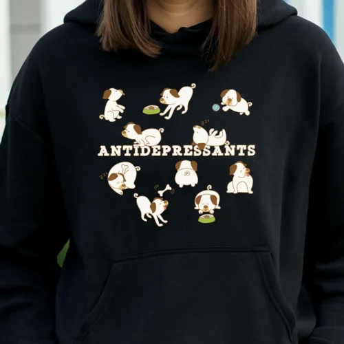 A funny black hoodie for dog lovers with cartoony pictures of funny dogs saying "Antidepressants".