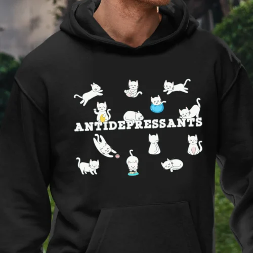 A funny hoodie for cat lovers with cartoony pictures of funny cats saying "Antidepressants", black color