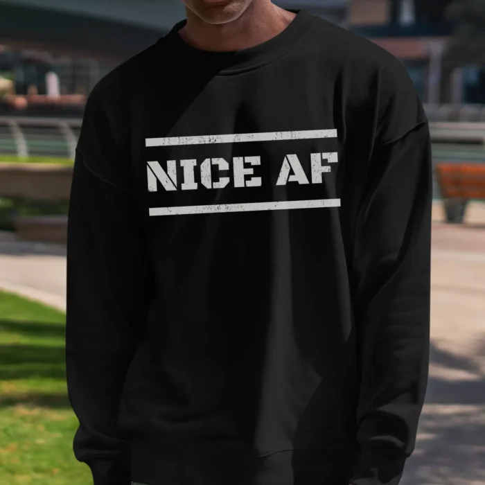 An African American man outside wearing a black Funny Sweatshirt saying "Nice AF".