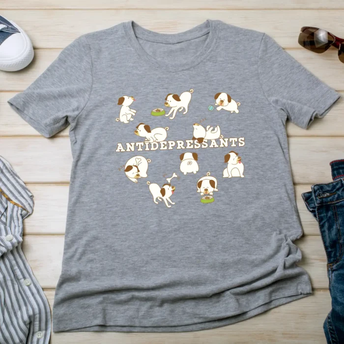 A funny gray T-Shirt for dog lovers with cartoony pictures of funny dogs saying "Antidepressants".