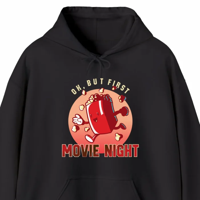 A funny hoodie with a cartoony picture of a popcorn box, saying "OK, but first movie night", black color