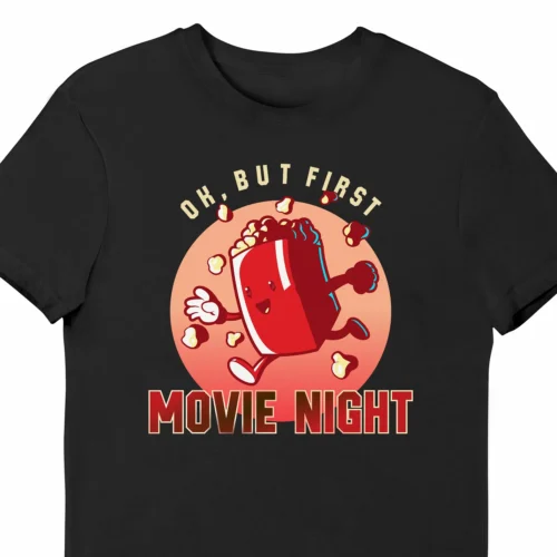 A funny t-shirt with a cartoony picture of a popcorn box, saying "OK, but first movie night", black color