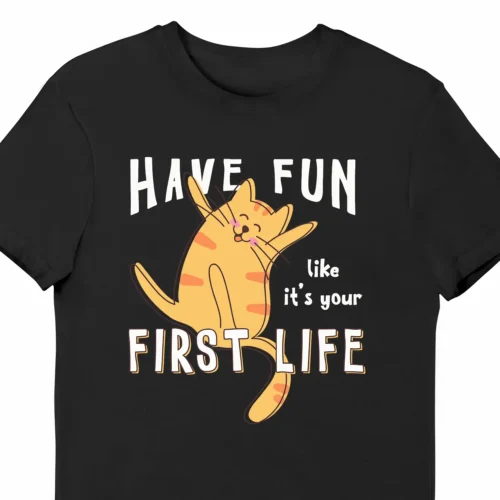 A funny t-shirt with a picture of a cute cat, saying "Have fun like it's your first life", black