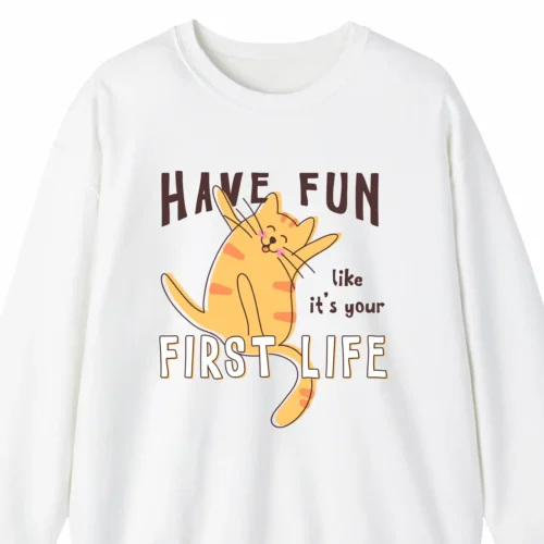 A funny sweatshirt with a picture of a cute cat, saying "Have fun like it's your first life", white