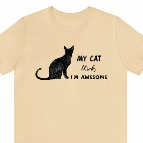 A funny t-shirt saying "My cat thinks I'm awesome", sand