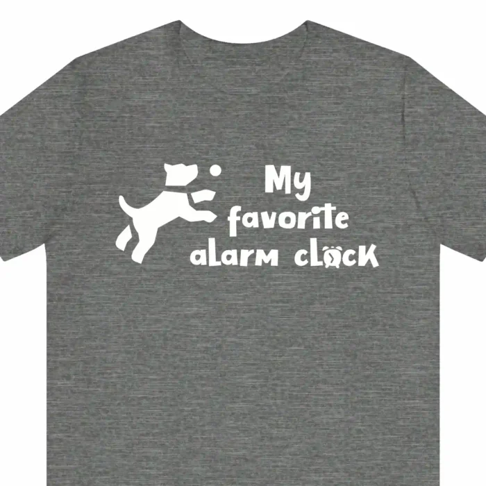 A funny t-shirt with a picture of a cute cartoony dog saying "My favorite alarm clock", gray color